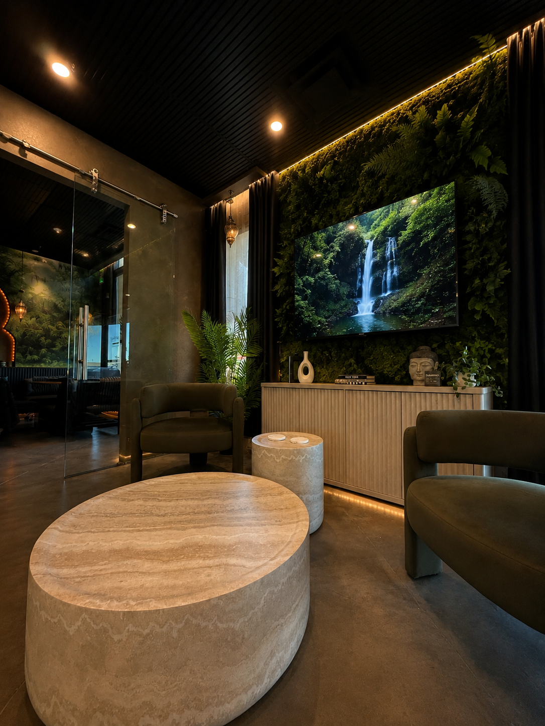 Quiet lounge at The Temple Head Spa Las Vegas with stone tables, low amber light, and Hindu-inspired textures